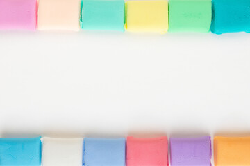 Colorful molded plasticine clay isolated on white background with copy space for text. Creativity children toys concept.