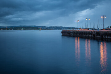 Oslofjord at evening with dramatic sky and pier, Oslo, Norway