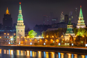 Fototapeta na wymiar Kremlin towers illuminated at evening with river reflection, Moscow, Russia