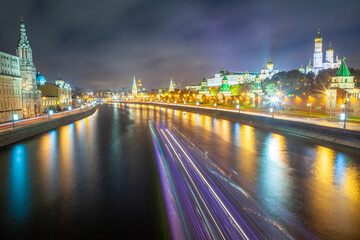 Fototapeta na wymiar Kremlin illuminated at night with river blurred light trail, Moscow, Russia