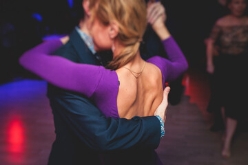 Couples dancing traditional latin argentinian dance milonga in the ballroom, tango salsa bachata...