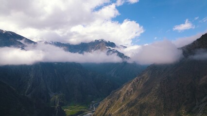 scenic drone shot of Dariali gorge from the clouds, Georgia. High quality photo