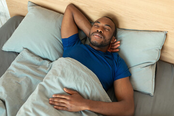 High Angle Shot Of Sleeping Black Man Napping In Bedroom