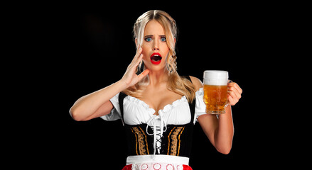 Oktoberfest 2022 in Munich. Sexy Oktoberfest girl waitress, wearing a traditional Bavarian or german dirndl, serving big beer mugs with drink isolated on black background.