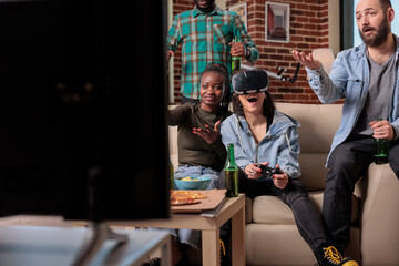 People playing video games with vr glasses at fun gathering, enjoying competition play with 3d headset simulation and virtual reality. Friends cheering to win game on tv console.