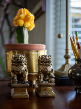 still life with foo dogs and plant on desk