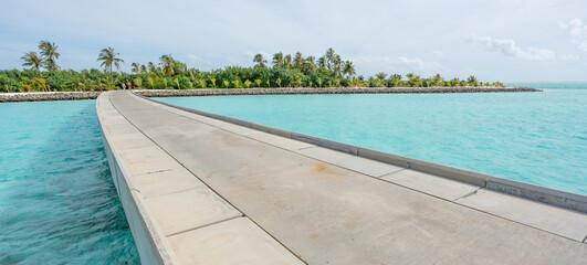 Fototapeta na wymiar Maldives resort bridge in tropical, exotic paradise with turquoise water