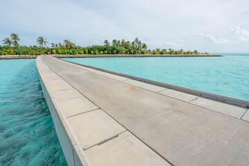 Fototapeta na wymiar Maldives resort bridge in tropical, exotic paradise with turquoise water