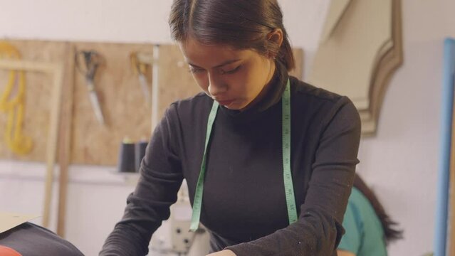 Latin women making clothes in an artisan workshop.