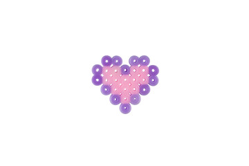 Heart made from small plastic cylinders on a white background. Handmade heart toy.