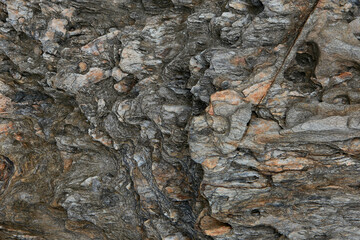 Rocks along the beach with traces of the natural beauty of the surface from the erosion of sea waves for a long time.The background image of the strange pattern of rocks from the sea waves.