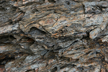 Rocks along the beach with traces of the natural beauty of the surface from the erosion of sea waves for a long time.The background image of the strange pattern of rocks from the sea waves.