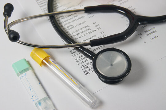Image of a stethoscope over the results of a blood test and urine and fecal occult blood tests