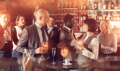 Portrait of man having fun and talking to woman on corporate party