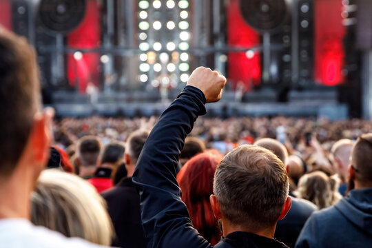 People with raised hands during the music concert.