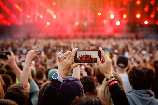 Recording a concert using a mobile phone. Smartphone at music show.