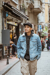 portrait of young male with denim jacket walking on historical city of istanbul