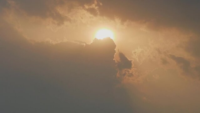 Beautiful sunset in evening time, rolling clouds raising up covering the sunlight, 4K Time lapse video, beautiful sky with clouds background, b roll shot.