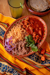 Mexican spicy pork stew - Mexican food whit chile colorado, rice and beans.
