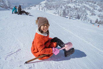 Fototapeta na wymiar happy little girl playing outside in the snow