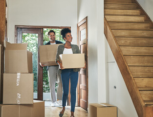 Interracial couple moving into a new modern house, carrying boxes and arriving home together. Happy, excited and smiling husband and wife walking, entering and relocating after buying an apartment - Powered by Adobe