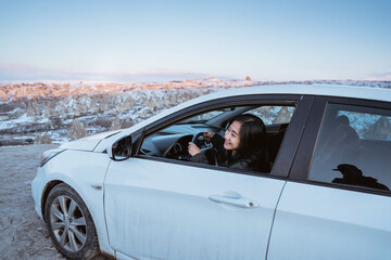 Fototapeta na wymiar woman driving a car off road to a beautiful landscape in cappadocia turkey