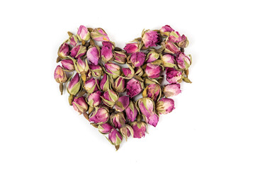 Fototapeta na wymiar Heart shape dehydrated pink rose buds top down view isolated over white