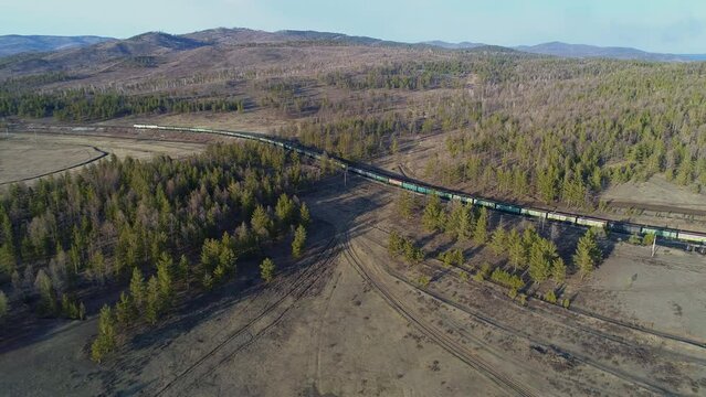 Cargo train in polar forests. Transportation of hard coal for heat generation at thermal power plants