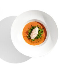 Summer Spanish soup gazpacho with crab meat and rucola isolated on white background. Delicious cold tomato soup with crab. Clean eating for diet.Healthy food in restaurant menu. Crab gazpacho