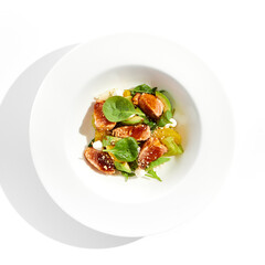 Healthy lunch - green salad with tuna, avocado and orange. Tuna salad for diet. Clean eating in restaurant menu. Grilled Fish with spinach, avocado, citrus isolated on white background. Keto diet.