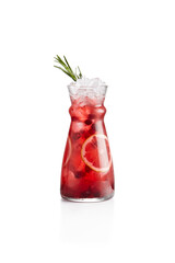 Cranberry lemonade with orange and rosemary in jug. Cranberry cocktail on white background. Cold cocktail in winter bar menu. Non alcoholic drinks. Lingonberry drink.