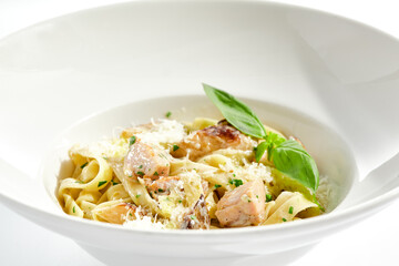 Traditional Italian lunch - pasta fettuccine with chicken and mushrooms with parmesan cheese. Creamy pasta with mushroom and chicken. Chicken and mushroom in cream sauce with homemade pasta.