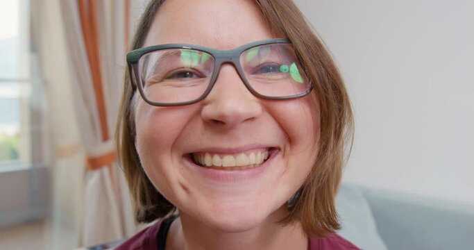 Portrait woman with puffy face in glasses standing close camera making different fake facial expressions. Change of emotions on face of sadness, resentment, joy. Psychological masks, feigned behavior