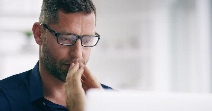 Thinking, serious and stressed business man working at an office computer praying. Male web and tech designer with bad stress about a work deadline. Tired worker worried about online research