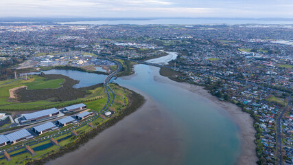 Fototapeta premium Aerial View from the Ocean, Forest, Green Trees, City Streets Football Soccer Field Seaside Park in Otahuhu, New Zealand - Auckland