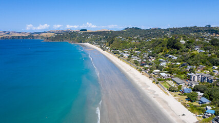 Fototapeta na wymiar Aerial View from Ocean, Beach, Green Trees and Mountains in Waiheke Island, New Zealand - Auckland Area