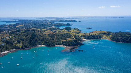 Fototapeta na wymiar Aerial View from Ocean, Beach, Green Trees and Mountains in Waiheke Island, New Zealand - Auckland Area