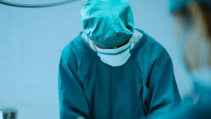 Surgery team operating in a surgical room. Doctor and nurse discuss planning surgery