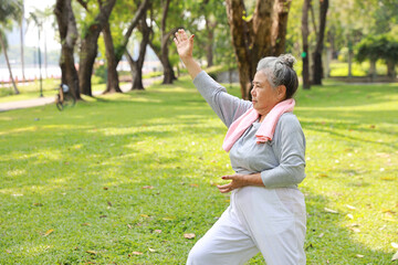 Asian senior woman practice yoga excercise, tai chi tranining, stretching and meditation together...