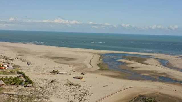 Flight above empty Macapa beach with exposed seabed during low tide; drone