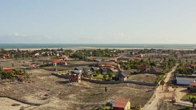Drone crane motion reveal Macapa village on Brazilian coastline in sunlight
