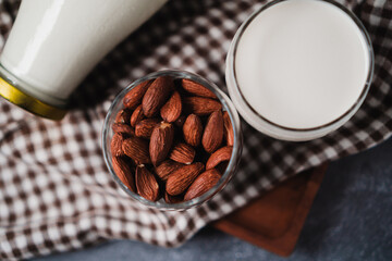 roasted almond and milk on a glass, top view