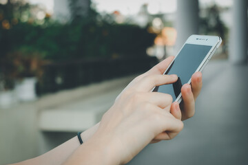 Close up of a woman hand using mobile smart phone.