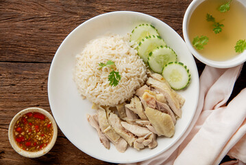 Hainanese chicken rice with soup on dark wooden table background. thaifood concept.