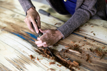 Female Restoring Old Fading Wooden table Close up on Hands
