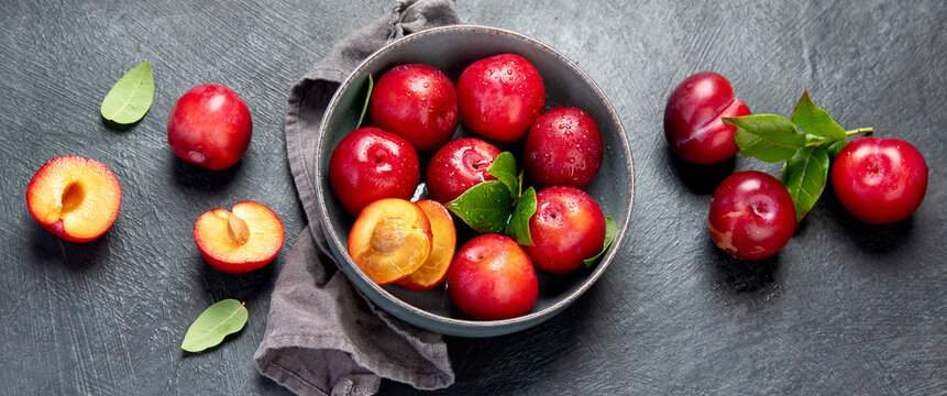 Fresh red plums in plate.