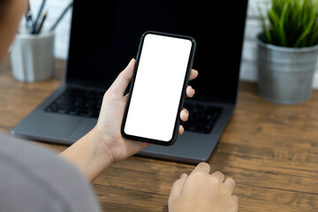 Hands of a woman using a  smartphone mockup at his desk, Mobile phone blank screen for editing graphics.