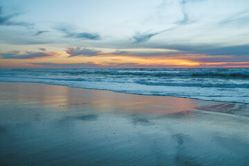Scenic seascape, sunset over the ocean. Tranquil scene, beautiful sun reflection and stormy ocean