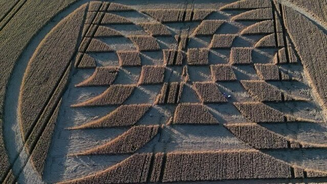 Aerial Of Intricate Patterns Carved In The Farm Field Of Micheldever Station During A Crop Circle Exhibition In England, UK. Drone Pullback