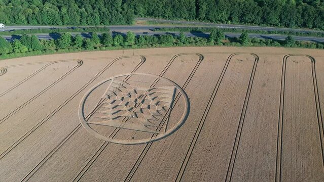 Agricultural Field With Crop Circle And Tractor Tracks In Micheldever Station, England. - aerial